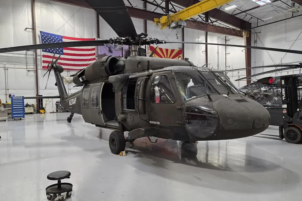 Castleberry UH-60 Black Hawk in a hangar under the US and Arizona flags