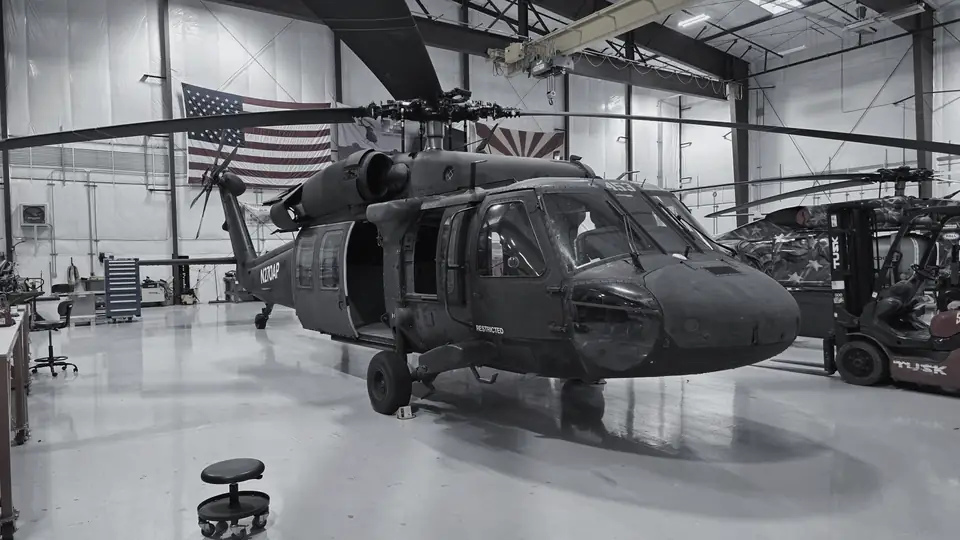 Castleberry UH-60 Black Hawk in a hangar under the US and Arizona flags