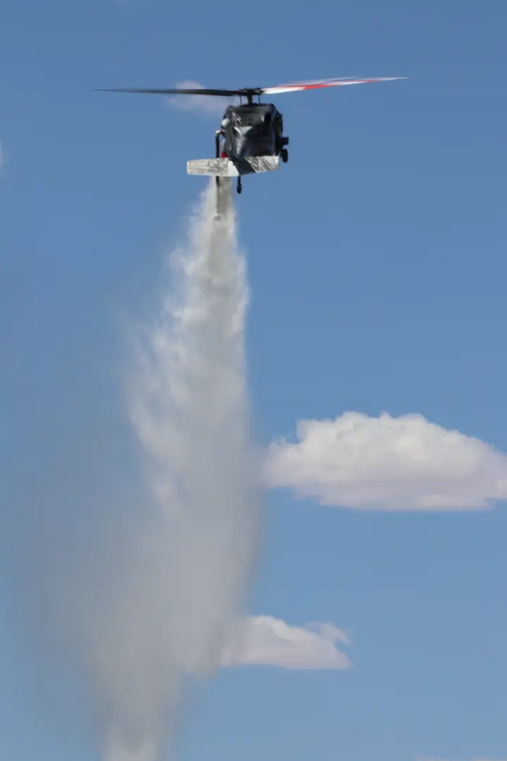 Castleberry Black Hawk releasing a water drop against a blue sky